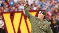 Washington Commanders head coach Dan Quinn runs onto the field prior to the Commanders' game against the Detroit Lions at Northwest Stadium.