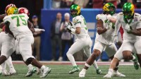 Jan 9, 2026; Atlanta, GA, USA; Oregon Ducks quarterback Dante Moore (5) drops back to pass against the Indiana Hoosiers during the first quarter of the 2025 Peach Bowl and semifinal game of the College Football Playoff at Mercedes-Benz Stadium.
