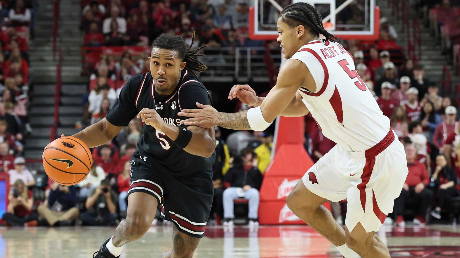 South Carolina Gamecocks guard Meechie Johnson (5) drives against Arkansas Razorbacks guard Darius Acuff Jr (5) during the second half at Bud Walton Arena. Arkansas won 108-74.