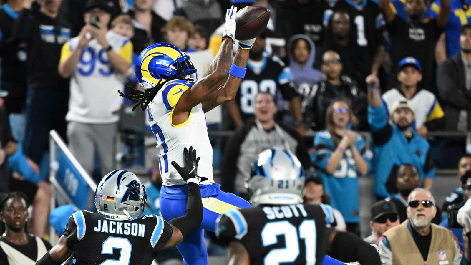 Los Angeles Rams wide receiver Davante Adams (17) makes a catch against the Carolina Panthers in the first half during the NFC Wild Card Round game at Bank of America Stadium.