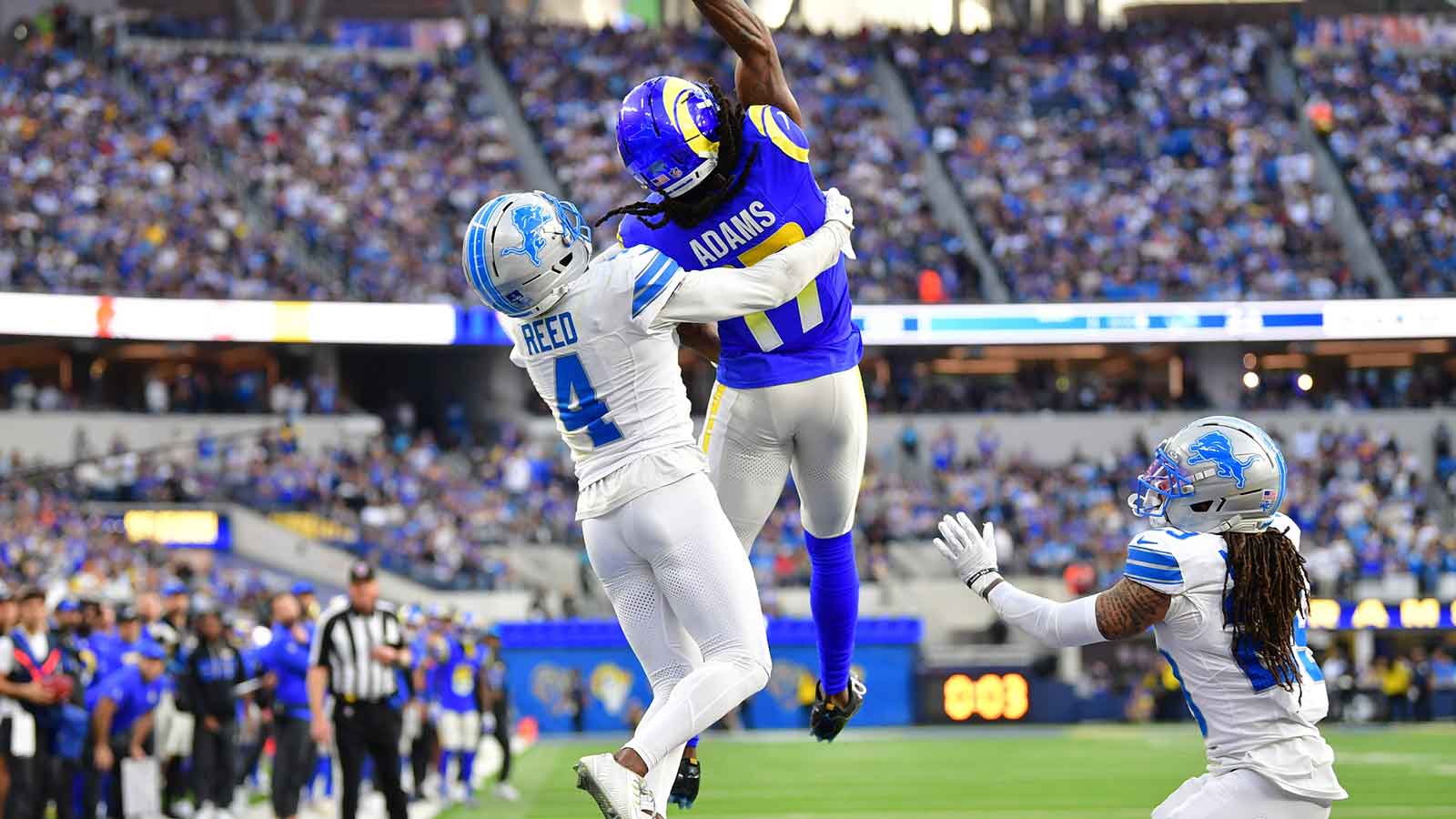 Los Angeles Rams wide receiver Davante Adams (17) goes up for a pass against Detroit Lions cornerback D.J. Reed (4) during the second quarter at SoFi Stadium. Mandatory Credit: Gary A. Vasquez-Imagn Images