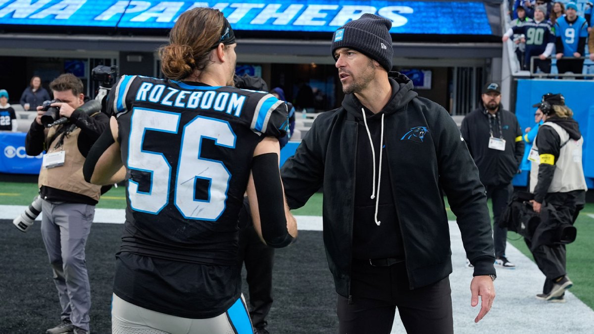 Carolina Panthers head coach Dave Canales thanks linebacker Christian Rozeboom (56) during the second half at Bank of America Stadium.
