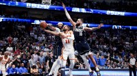 Dallas Mavericks forward Anthony Davis (3) and Dallas Mavericks forward Caleb Martin (16) defend the shot of Atlanta Hawks guard Trae Young (11) during the fourth quarter at American Airlines Center.