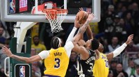 Milwaukee Bucks forward Giannis Antetokounmpo (34) puts up a shot against Los Angeles Lakers forward Anthony Davis (3) and Los Angeles Lakers forward Rui Hachimura (28) in the second overtime at Fiserv Forum
