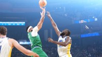 Dallas Mavericks forward Anthony Davis (center left) shoots against Golden State Warriors forward Draymond Green (center right) during the first quarter at Chase Center.