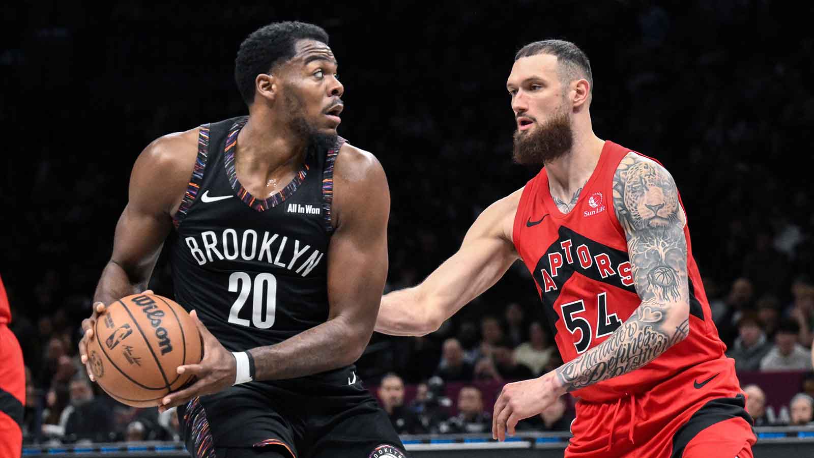 Brooklyn Nets center Day'Ron Sharpe (20) looks to pass the ball as Toronto Raptors forward/center Sandro Mamukelashvili (54) defends during the first half at Barclays Center.