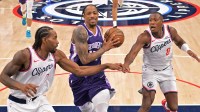 Los Angeles Clippers forward Kawhi Leonard (2) and guard Kris Dunn (8) defend Sacramento Kings guard Demar Derozan (10) as he drives to the basket in the second half at Intuit Dome.