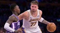 Dec 28, 2025; Los Angeles, California, USA; Sacramento Kings guard Dennis Schroder (17) defemds Los Angeles Lakers guard Luka Doncic (77) in the second half at Crypto.com Arena. Mandatory Credit: Jayne Kamin-Oncea-Imagn Images