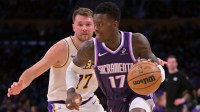Sacramento Kings guard Dennis Schroder (17) drives past Los Angeles Lakers guard Luka Doncic (77) in the first half at Crypto.com Arena.
