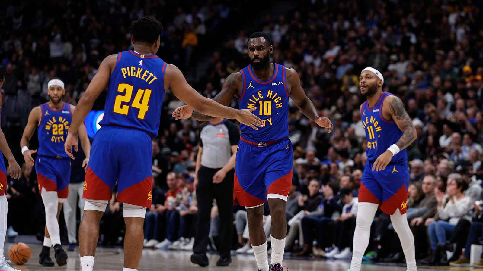 Denver Nuggets guard Tim Hardaway Jr. (10) reacts with guard Jalen Pickett (24) ahead of guard Bruce Brown (11) in the third quarter against the Milwaukee Bucks at Ball Arena.