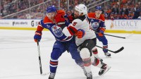 New Jersey Devils defensemen Brendan Dillon (5) knocks Edmonton Oilers forward Connor McDavid (97) off the puck during the third period at Rogers Place.
