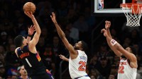 Phoenix Suns guard Devin Booker (1) shoots the ball against New York Knicks guard Mikal Bridges (25) in the second half at Mortgage Matchup Center.