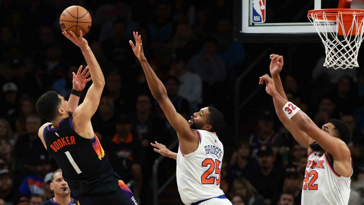 Phoenix Suns guard Devin Booker (1) shoots the ball against New York Knicks guard Mikal Bridges (25) in the second half at Mortgage Matchup Center.