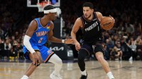 Phoenix Suns guard Devin Booker (1) controls the ball against Oklahoma City Thunder guard Shai Gilgeous-Alexander (2) in the second half at Mortgage Matchup Center.