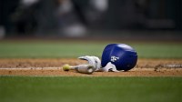 A view of a Los Angeles Dodgers batting helmet and bat during the game between the Texas Rangers and the Los Angeles Dodgers at Globe Life Field.