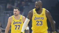 Los Angeles Lakers guard Luka Doncic (77) and forward LeBron James (23) stand on the court in the first quarter against the Cleveland Cavaliers at Rocket Arena.