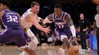 Sacramento Kings guard Dennis Schroder (17) drives past Los Angeles Lakers guard Luka Doncic (77) in the first half at Crypto.com Arena.