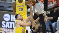 Los Angeles Lakers guard Luka Doncic (77) shoots beside Cleveland Cavaliers guard Jaylon Tyson (20) in the second quarter at Rocket Arena.