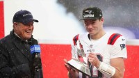 New England Patriots quarterback Drake Maye (10) holds the AFC Championship trophy while speaking to the media after defeating the Denver Broncos in the 2026 AFC Championship Game at Empower Field at Mile High.