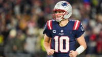 New England Patriots quarterback Drake Maye (10) smiles after a touchdown pass during the fourth quarter against the Los Angeles Chargers in an AFC Wild Card Round game at Gillette Stadium.