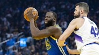 Utah Jazz forward Kevin Love (42) defends as Golden State Warriors forward Draymond Green (23) passes during the first quarter at Chase Center.