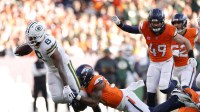 Green Bay Packers running back Josh Jacobs (8) is tackled by Denver Broncos linebacker Dre Greenlaw (57) during the second quarter at Empower Field at Mile High.