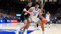 Duke Blue Devils forward Cameron Boozer (12) controls the ball in front of Wake Forest Demon Deacons forward Cooper Schwieger (13) during the second half at Cameron Indoor Stadium.
