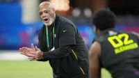 Pittsburgh Steelers defensive line coach Karl Dunbar encourages Toledo defensive lineman Darius Alexander (DL02) during the 2025 NFL Combine at Lucas Oil Stadium.