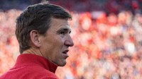 Eli Manning stands on the sideline before the first round of the College Football Playoff.