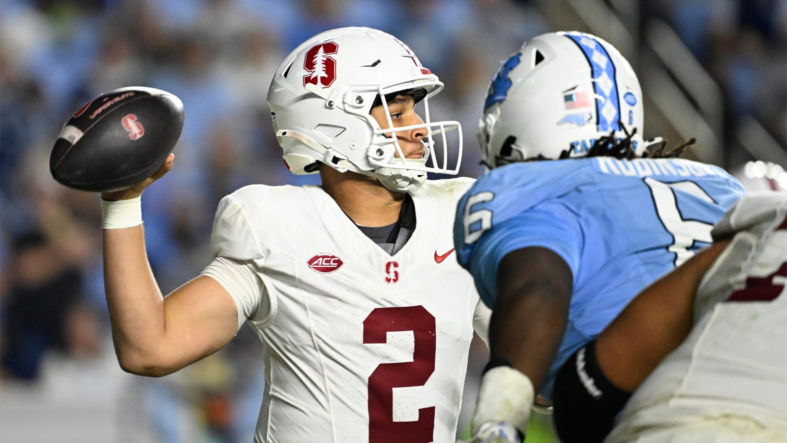 Stanford Cardinal quarterback Elijah Brown (2) looks to pass as North Carolina Tar Heels defensive tackle D'Antre Robinson (6) pressures in the third quarter at Kenan Stadium. Mandatory Credit: Bob Donnan-Imagn Images