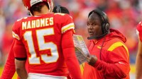 Kansas City Chiefs offensive coordinator Eric Bieniemy talks with quarterback Patrick Mahomes (15) during the second half against the Buffalo Bills at GEHA Field at Arrowhead Stadium.