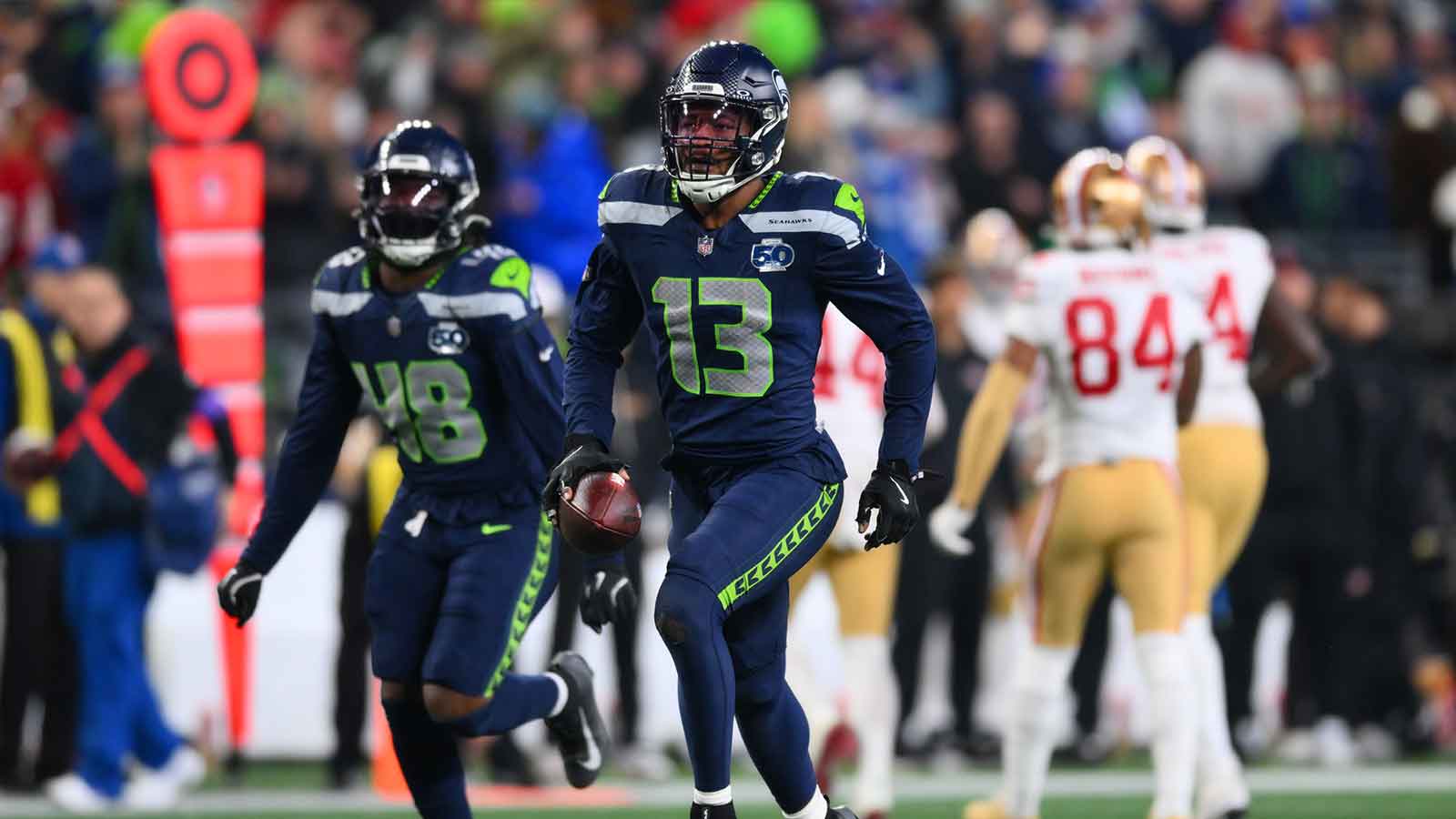 Seattle Seahawks linebacker Ernest Jones IV (13) reacts after an interception against the San Francisco 49ers during the second half in an NFC Divisional Round game at Lumen Field.