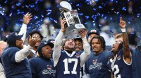 Penn State Nittany Lions quarterback Ethan Grunkemeyer (17) and teammates celebrate with the George M. Steinbrenner Trophy after defeating the Clemson Tigers in the 2025 Pinstripe Bowl at Yankee Stadium.