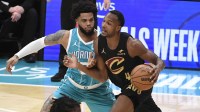 Cleveland Cavaliers forward center Evan Mobley (4) drives past Charlotte Hornets forward Miles Bridges (0) during the first half at the Spectrum Center.
