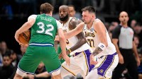 Dallas Mavericks forward Cooper Flagg (32) looks to move the ball past Los Angeles Lakers forward LeBron James (23) and guard Luka Doncic (77) during the second half at the American Airlines Center.