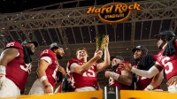 Indiana Hoosiers quarterback Fernando Mendoza (15) hoists the championship trophy Monday, Jan. 19, 2026, after defeating the Miami (FL) Hurricanes in the College Football Playoff National Championship college football game at Hard Rock Stadium in Miami Gardens.