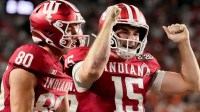 Indiana Hoosiers quarterback Fernando Mendoza (15) celebrates with his teammates after rushing for a touchdown Monday, Jan. 19, 2026, during the College Football Playoff National Championship college football game at Hard Rock Stadium in Miami Gardens.