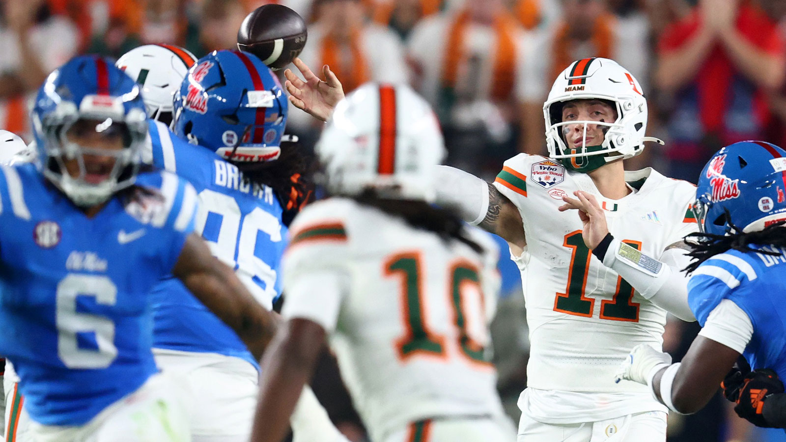 Miami Hurricanes quarterback Carson Beck (11) returns and passes against the Mississippi Rebels in the first half during the 2026 Fiesta Bowl and College Football Playoff semifinal game at State Farm Stadium.