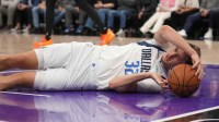 Dallas Mavericks forward Cooper Flagg (32) lays on the ground after being fouled against the Sacramento Kings in the third quarter at the Golden 1 Center.
