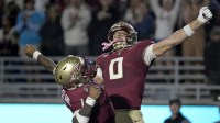 Florida State Seminoles quarterback Tommy Castellanos (1) celebrates a touchdown with wide receiver Duce Robinson (0) during the second half against the Wake Forest Demon Deacons at Doak S. Campbell Stadium.