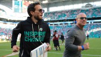 Miami Dolphins head coach Mike McDaniel runs off the field following a win over the Tampa Bay Buccaneers at Hard Rock Stadium.