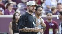 Former Texas A&M Aggies player Johnny Manziel watches from the sideline during the first half of the game between the Aggies and the Louisiana Monroe Warhawks at Kyle Field.