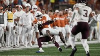 Texas Longhorns running back CJ Baxter Jr (4) is tackled after catching a pass during the second half against the Texas A&M Aggies at Darrell K Royal-Texas Memorial Stadium.