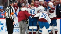 Colorado Avalanche left wing Gabriel Landeskog (92) is helped by center Nathan MacKinnon (29) to get off the ice after an injury against the Florida Panthers during the second period at Amerant Bank Arena.