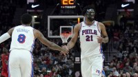 Philadelphia 76ers center Joel Embiid (21) and forward Paul George (8) high five during the second half against the Portland Trail Blazers at Moda Center