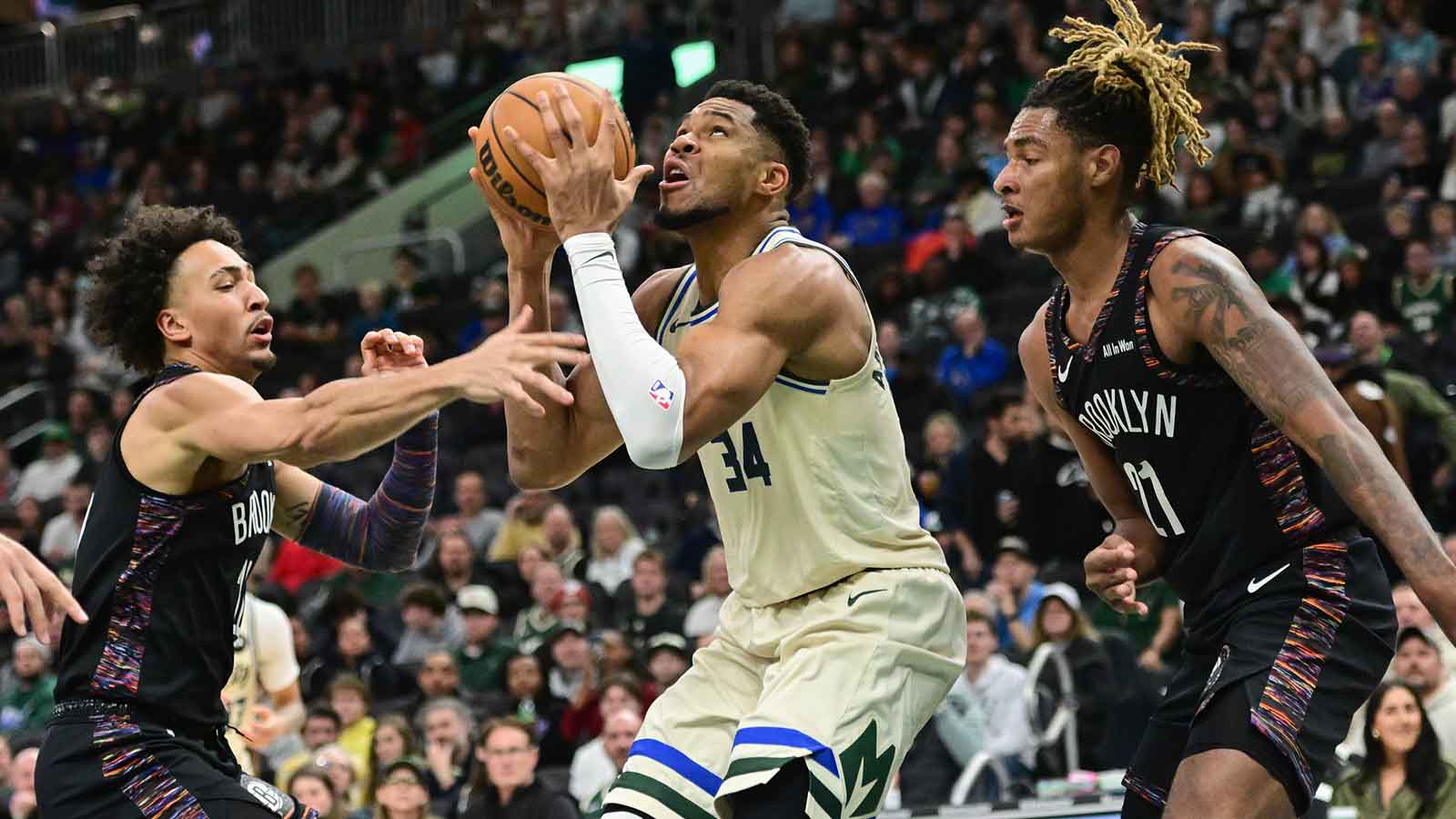 Milwaukee Bucks forward Giannis Antetokounmpo (34) looks for a shot between Brooklyn Nets forward Jalen Wilson (22) and forward Noah Clowney (21) in the second quarter at Fiserv Forum.
