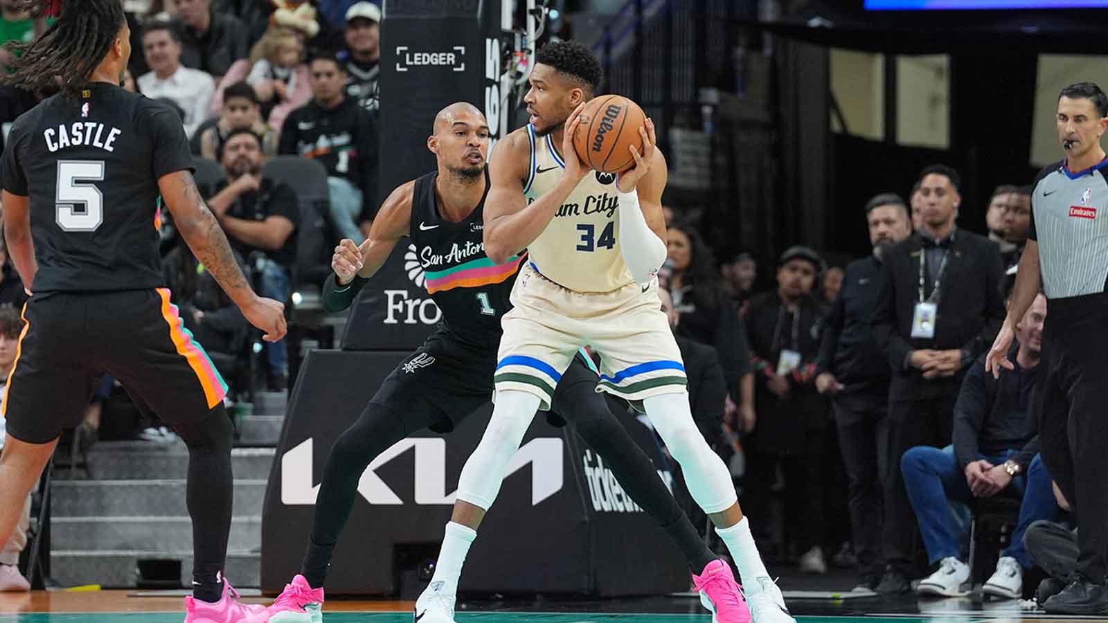 Milwaukee Bucks forward Giannis Antetokounmpo (34) backs up against San Antonio Spurs forward/center Victor Wembanyama (1) in the first half at Frost Bank Center. 