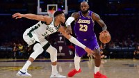 Los Angeles Lakers forward LeBron James (23) moves the ball against Milwaukee Bucks forward Giannis Antetokounmpo (34) during the second half at Crypto.com Arena
