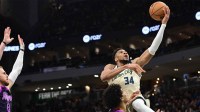 Milwaukee Bucks forward Giannis Antetokounmpo (34) takes a shot against Minnesota Timberwolves center Joan Beringer (19) in the third quarter at Fiserv Forum.