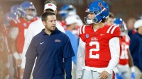 Mississippi Rebels offensive coordinator Charlie Weis Jr. (left) talks with quarterback Jaxson Dart (2) during warm ups prior to the game against the Vanderbilt Commodores at Vaught-Hemingway Stadium.